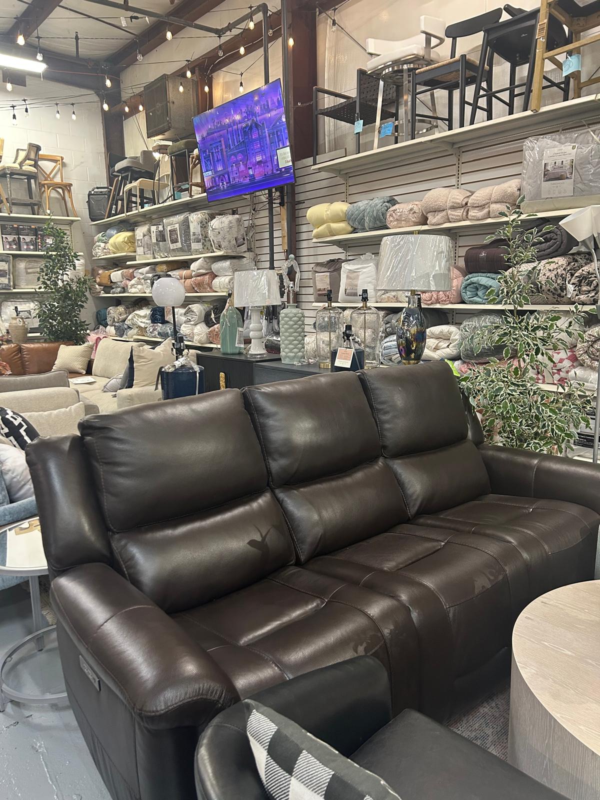 Dark reclining sofa inside the Fast Design showroom